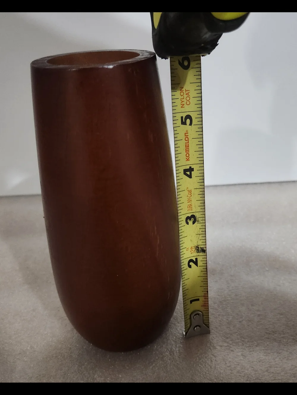 Vintage, mid-century modern style candle holder is crafted from turned wood with